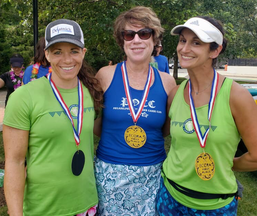 Photo ofthree women wearing medals